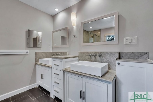 bathroom with tile patterned floors, vanity, and walk in shower