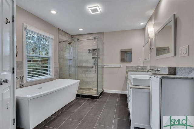 bathroom featuring separate shower and tub and vanity