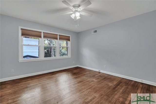 empty room featuring dark hardwood / wood-style floors and ceiling fan