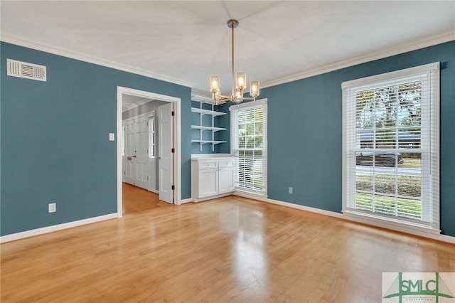 unfurnished dining area featuring light wood-type flooring, an inviting chandelier, and crown molding