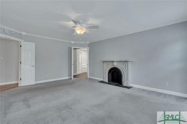 unfurnished living room with carpet, ceiling fan, crown molding, and a premium fireplace