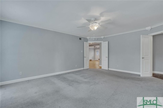 carpeted spare room featuring ceiling fan and crown molding