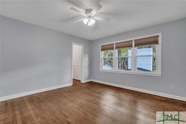 empty room with hardwood / wood-style floors and ceiling fan