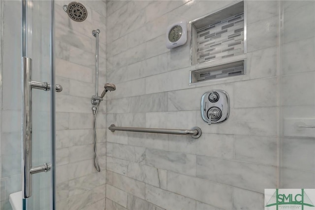 bathroom featuring a shower with shower door