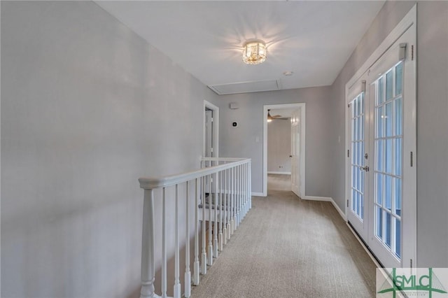 hallway with light carpet and french doors