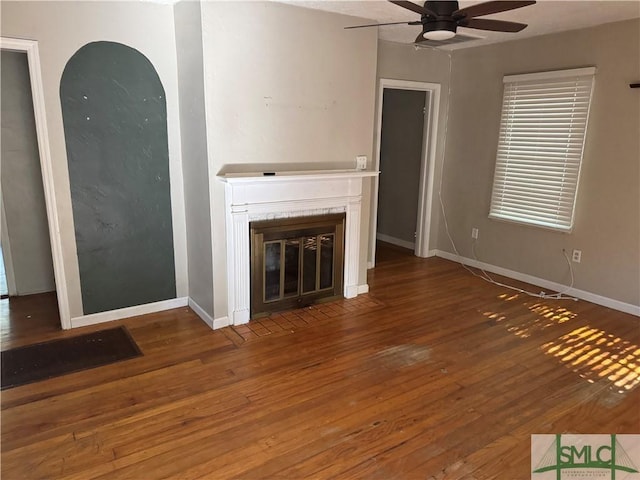 unfurnished living room featuring hardwood / wood-style flooring and ceiling fan