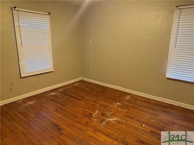 spare room with dark wood-type flooring