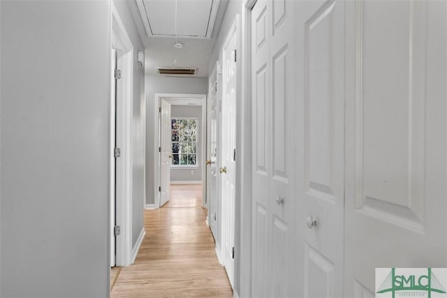 corridor with light hardwood / wood-style floors