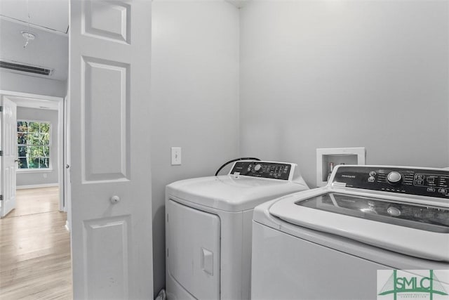 washroom featuring independent washer and dryer and light hardwood / wood-style floors