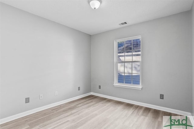 spare room featuring light hardwood / wood-style flooring