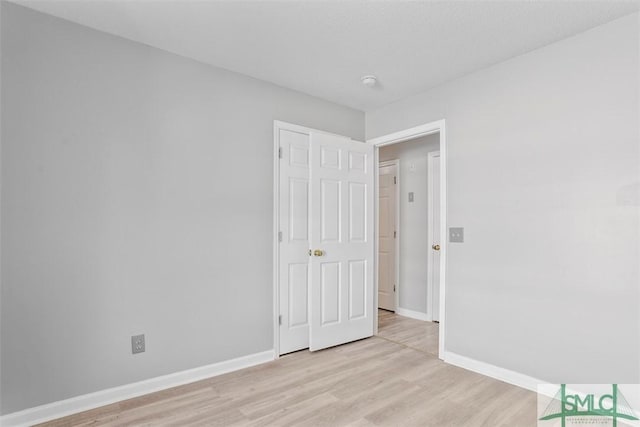 spare room with light hardwood / wood-style flooring