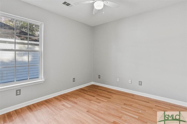 empty room with hardwood / wood-style flooring and ceiling fan