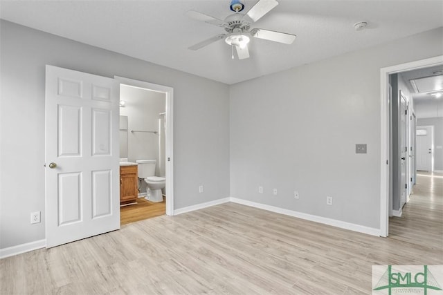 unfurnished bedroom with ceiling fan, light wood-type flooring, and ensuite bath