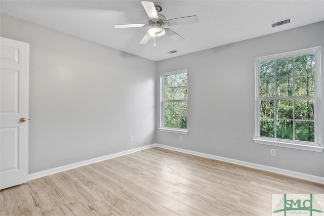 spare room featuring light hardwood / wood-style floors and ceiling fan