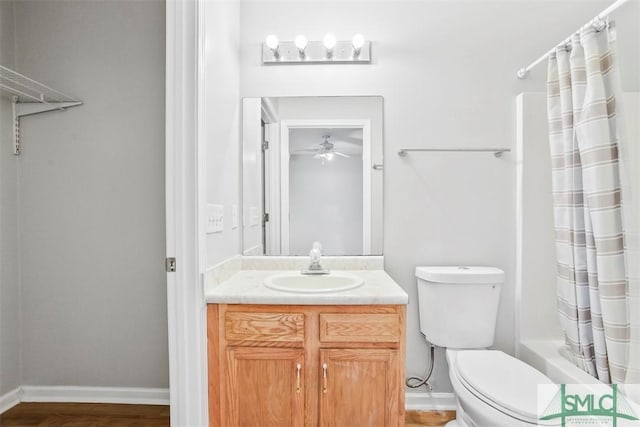 full bathroom featuring ceiling fan, shower / bathtub combination with curtain, toilet, vanity, and hardwood / wood-style flooring