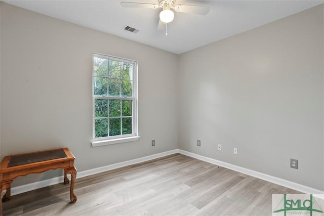 spare room featuring light hardwood / wood-style flooring and ceiling fan