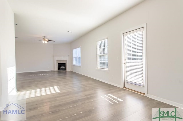 unfurnished living room with ceiling fan and wood-type flooring