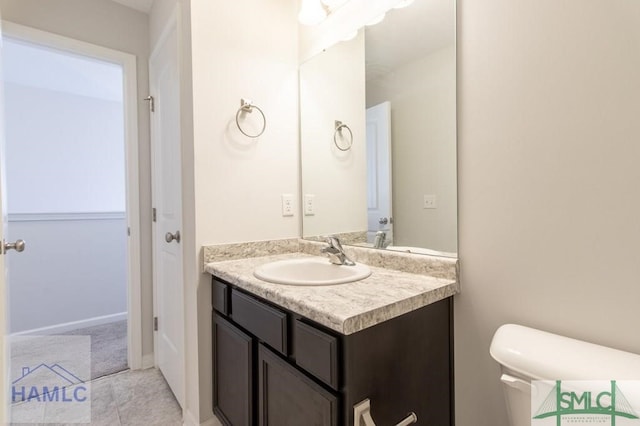 bathroom with toilet and vanity