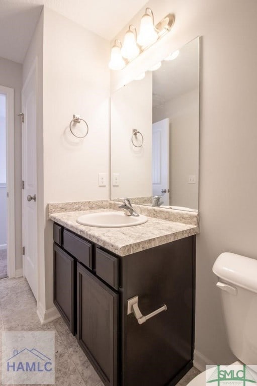 bathroom with toilet and vanity