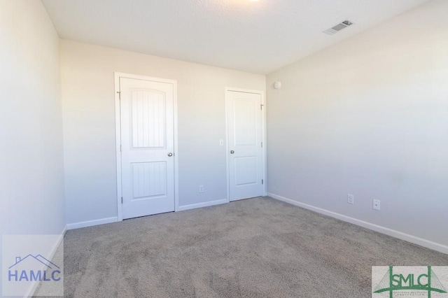 unfurnished bedroom featuring a closet and light carpet