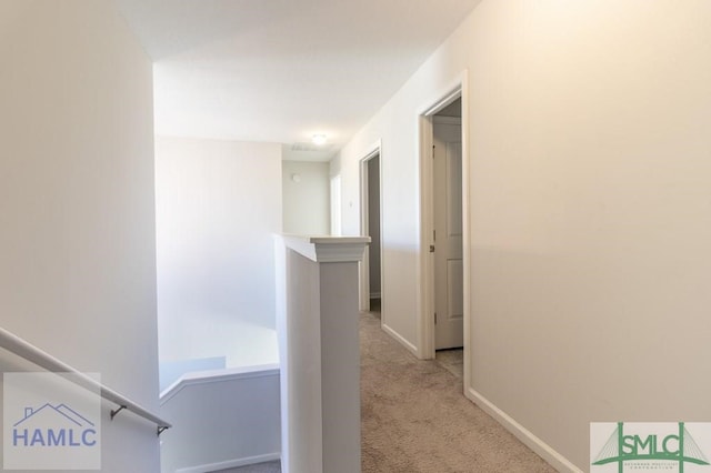 hallway with light colored carpet