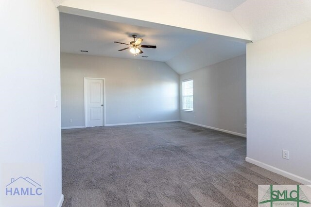 carpeted empty room with ceiling fan and lofted ceiling