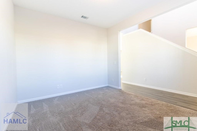 empty room featuring dark carpet