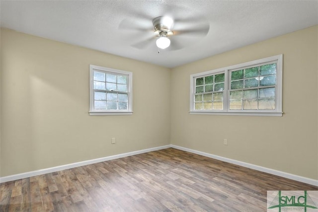 spare room featuring ceiling fan, a textured ceiling, and hardwood / wood-style flooring