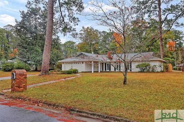 ranch-style house with a garage and a front yard