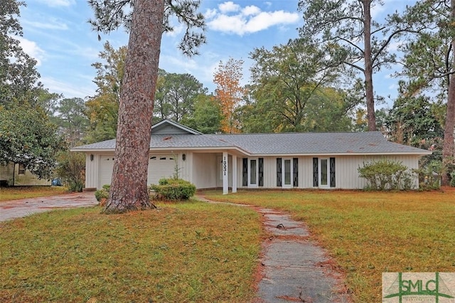 ranch-style house with a front yard and a garage