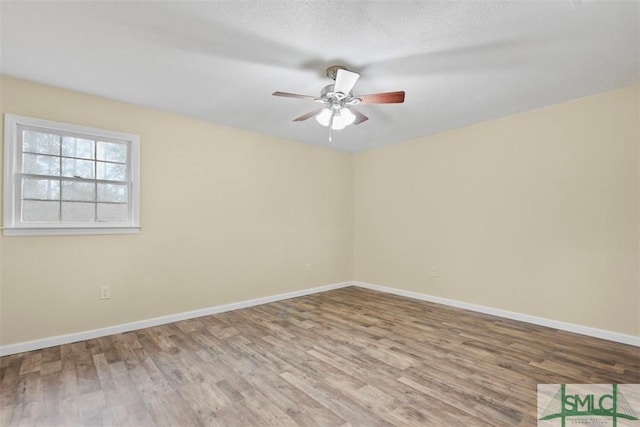 unfurnished room with a textured ceiling, hardwood / wood-style flooring, and ceiling fan