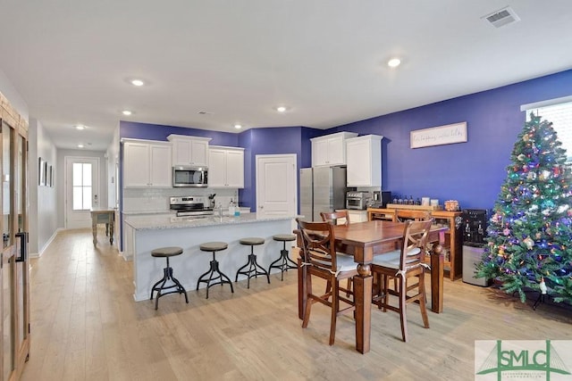 dining space with light wood-type flooring