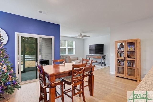 dining area with ceiling fan and light wood-type flooring