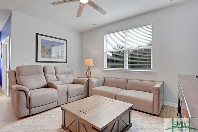 living room with ceiling fan and light hardwood / wood-style floors