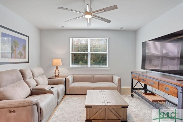 living room with light carpet and ceiling fan