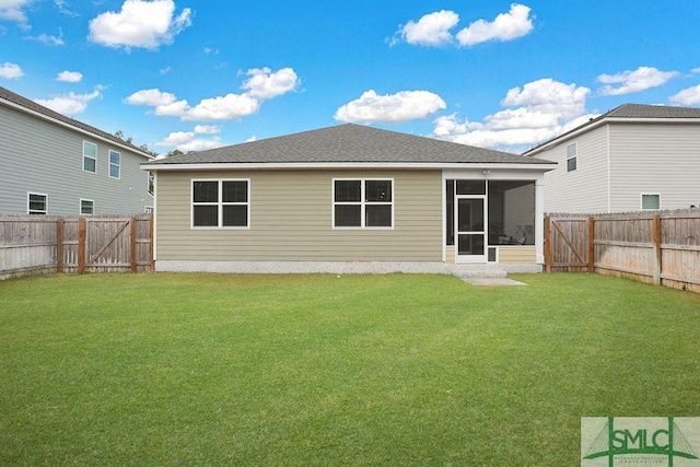 back of property featuring a sunroom and a lawn