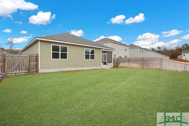 rear view of house with a lawn