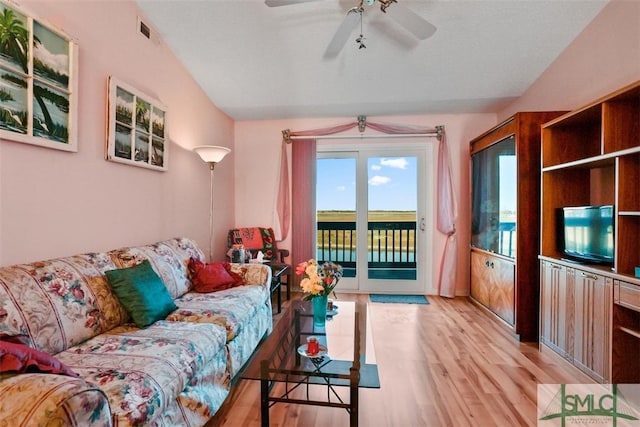 living room with ceiling fan and light hardwood / wood-style flooring