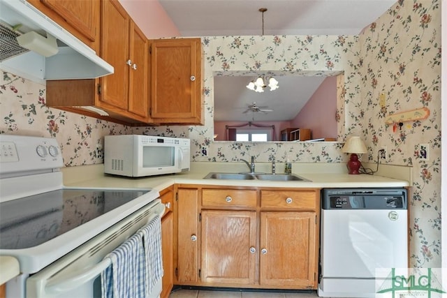 kitchen featuring ceiling fan, sink, white appliances, and decorative light fixtures