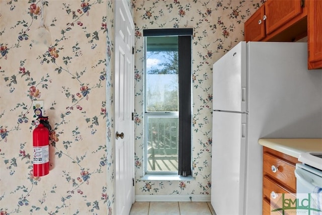 interior space featuring light tile patterned floors, plenty of natural light, and white fridge