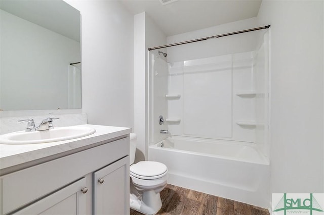 full bathroom with shower / bathing tub combination, wood-type flooring, vanity, and toilet