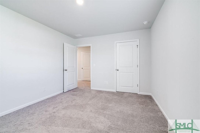 unfurnished bedroom with light colored carpet