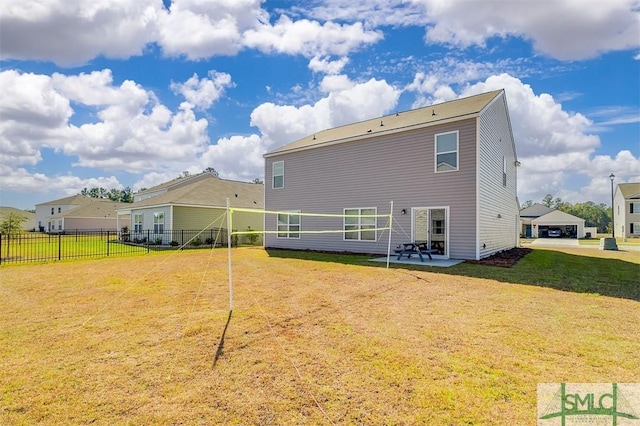 rear view of property featuring a patio and a lawn