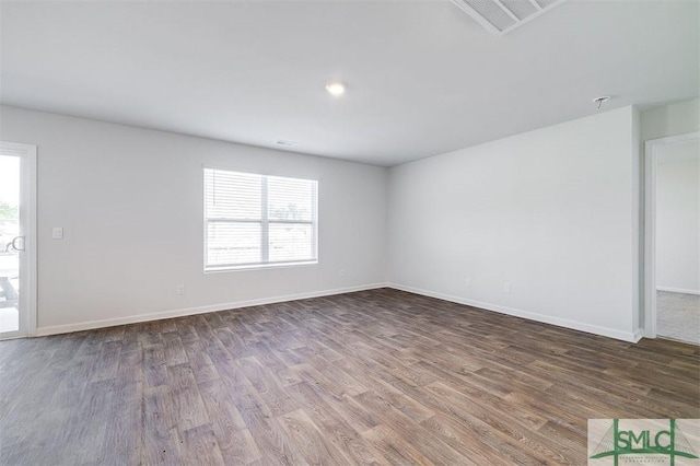 spare room featuring wood-type flooring