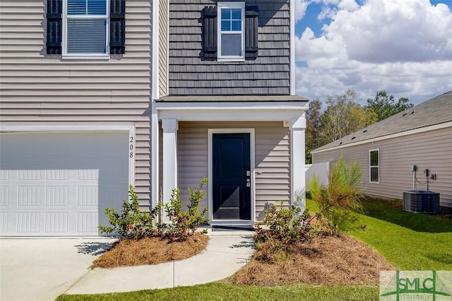 view of exterior entry with cooling unit and a garage