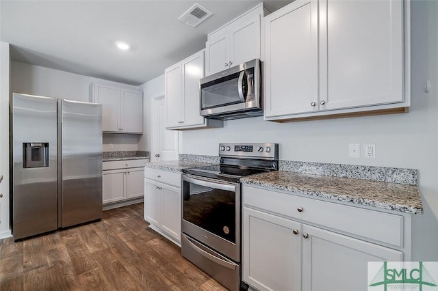 kitchen featuring light stone countertops, stainless steel appliances, white cabinetry, and dark wood-type flooring