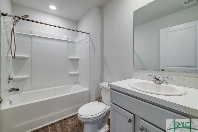 full bathroom with vanity, hardwood / wood-style floors,  shower combination, and toilet