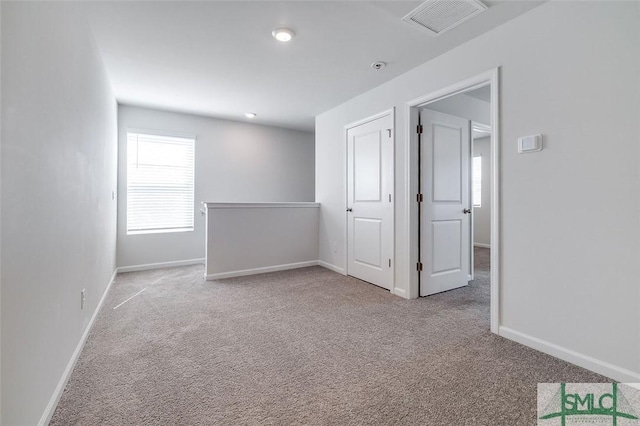 spare room with light colored carpet