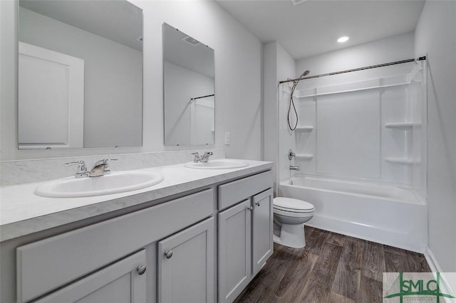 full bathroom with vanity, toilet, shower / bathing tub combination, and hardwood / wood-style flooring