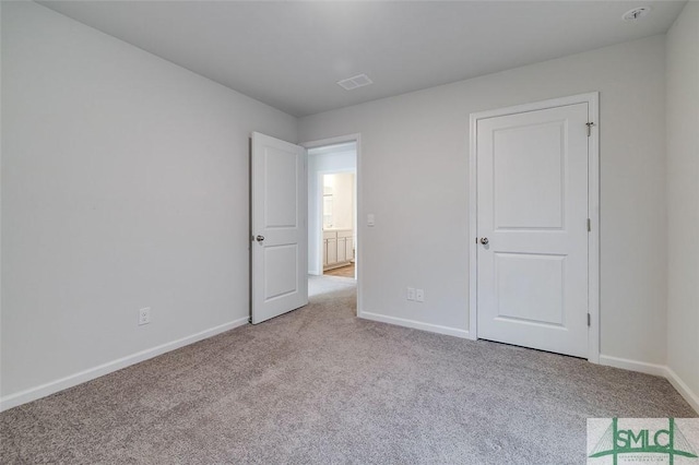 unfurnished bedroom featuring light colored carpet